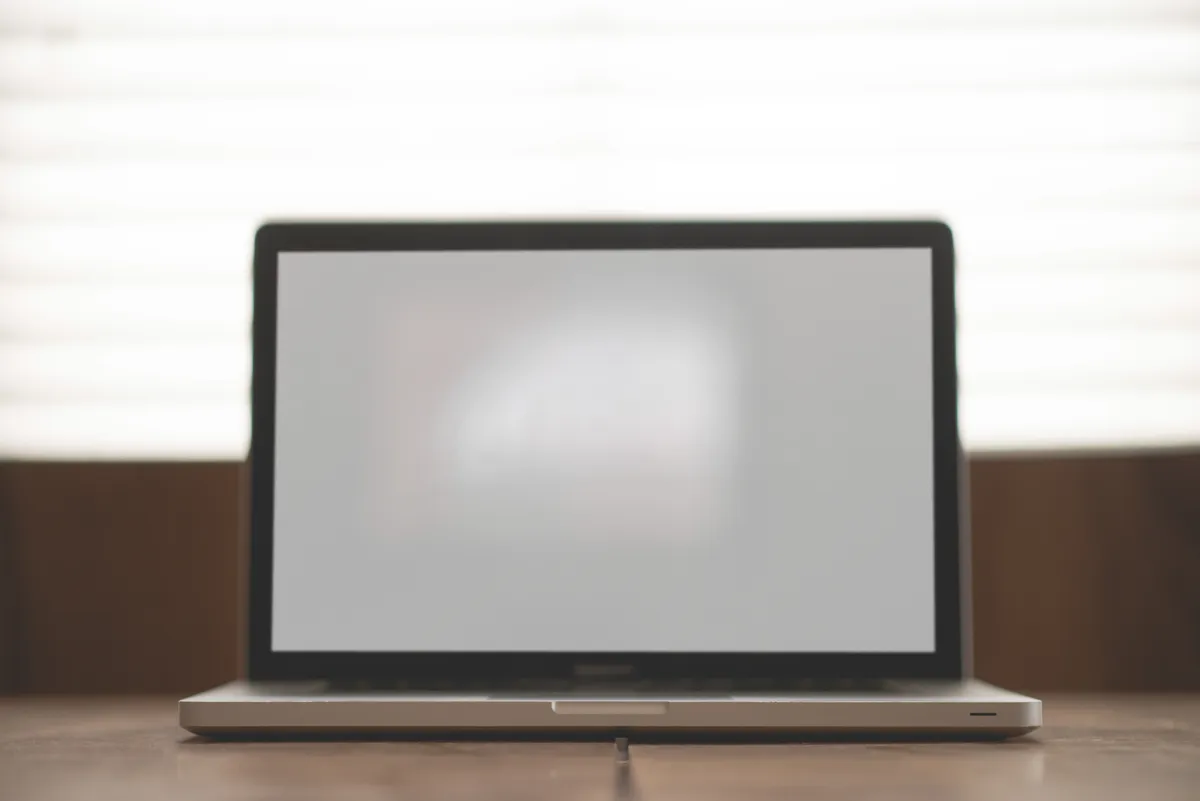 Raycast vs Alfred 2026 — MacBook desk workspace
